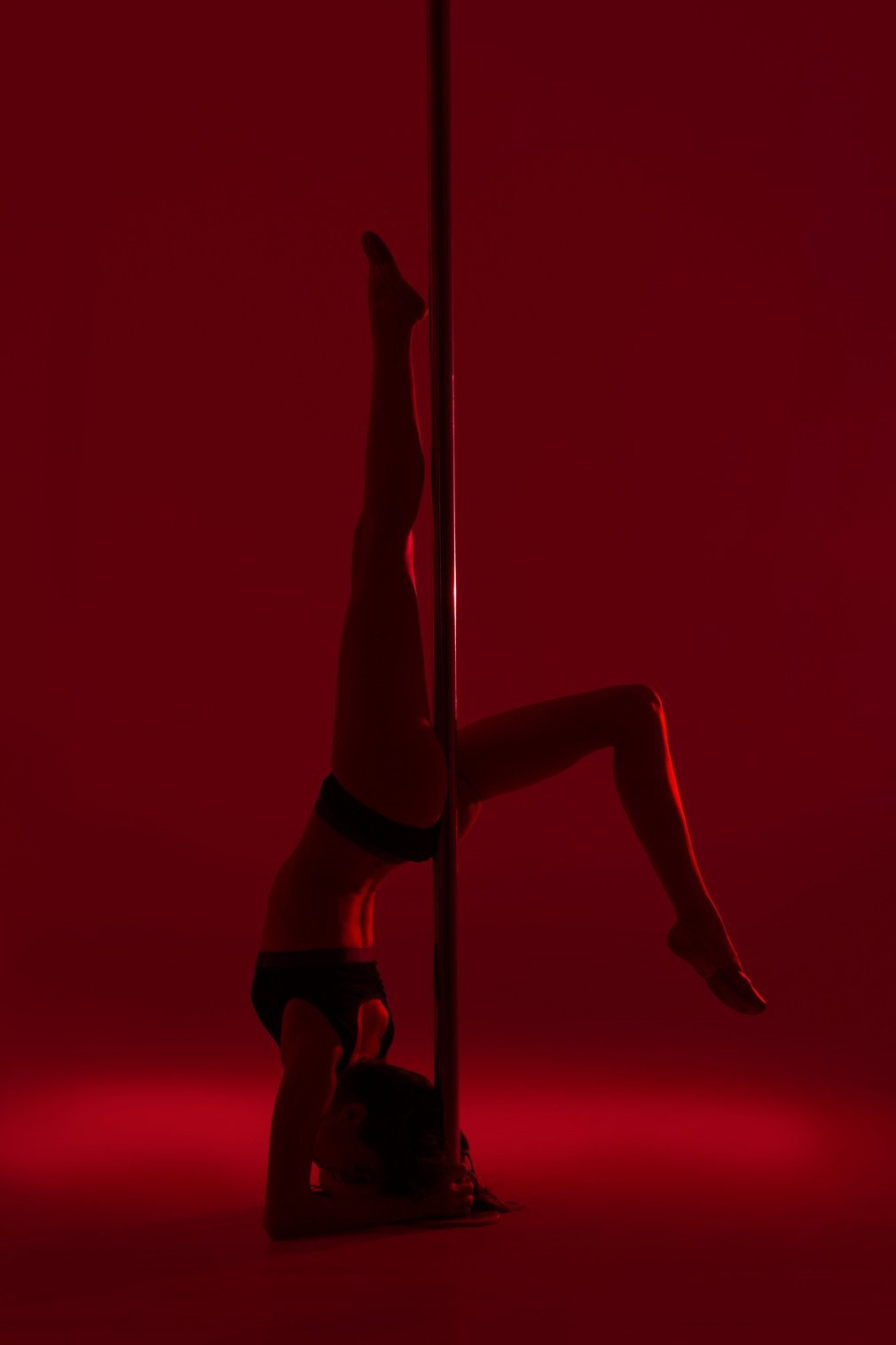 Young Beautiful Girl Doing Pole Dancing Exercise